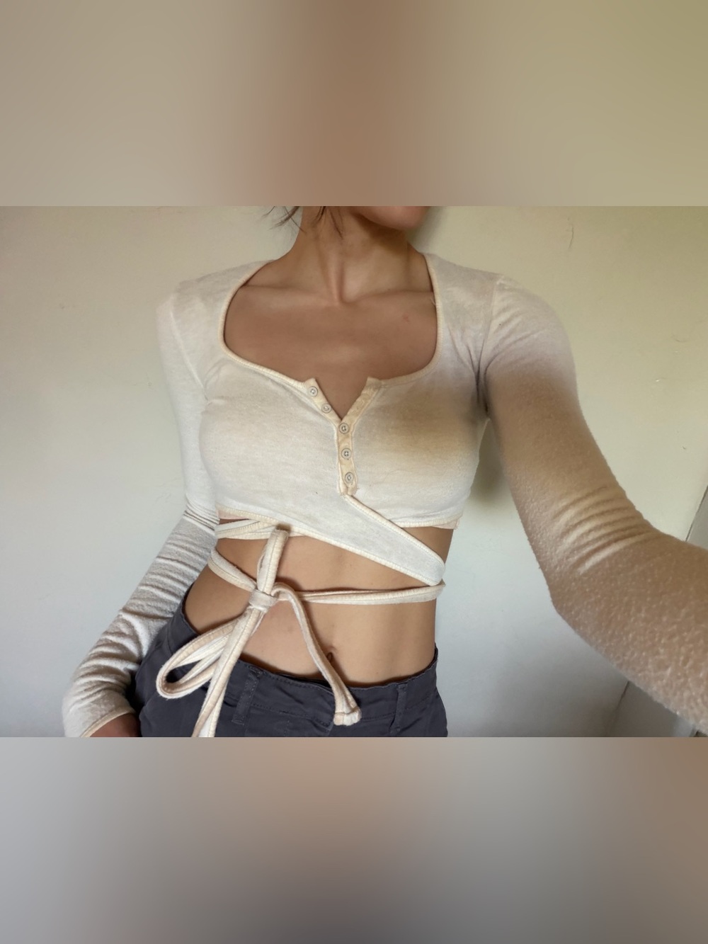 Urban Outfitters cream cropped long sleeve with tie. Size small.